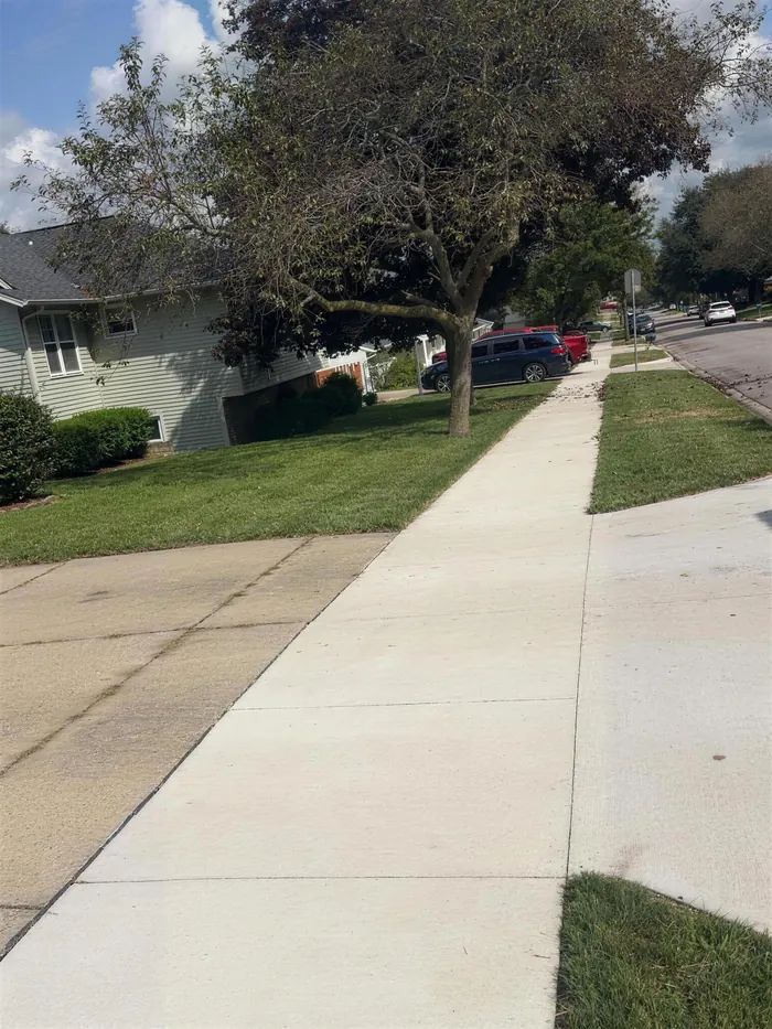 Clean cut grass line along a sidewalk